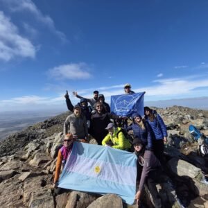 Grupo con la bandera argentina en la cumbre del Tres Picos
